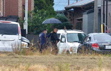 殺害現場に立ち会う多久容疑者=豊橋市大村町で(12月13日撮影)
