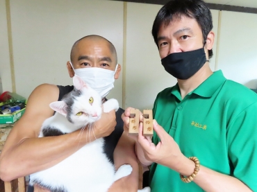 保護猫を抱く坪井住職㊧と石原さん=西光院で