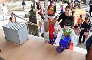 床材も新装された拝殿に入るお稚児さんたち=為当稲荷神社で