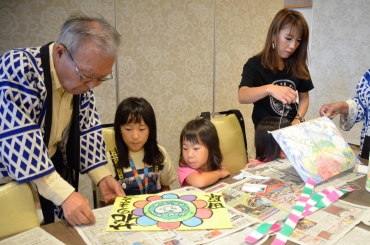 自分で考え、描いてきた和紙で凧を作る子どもら=道の駅田原めっくんはうすで