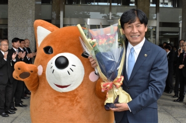 いなりんから就任祝いの花束を贈られ、笑顔の竹本市長=豊川市役所で
