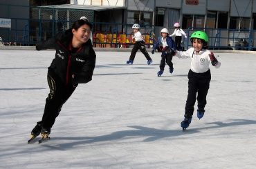 選手と氷上鬼ごっこをする児童たち=愛知こどもの国あさひが丘スケートリンクで