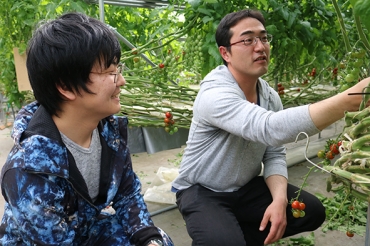 ミニトマト農家の冨永さん㊨と求職者の宇田さん(JAひまわり提供)
