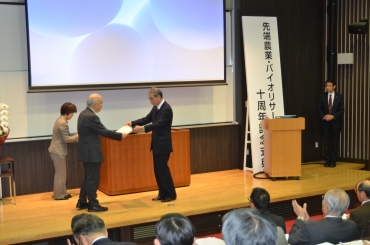式典で表彰される三枝特命教授㊨=豊橋技術科学大学で