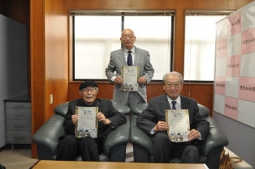 チラシを持つ高須さん(後列)。顧問の伊奈さんと神野紀郎さん(前列左から)=東愛知新聞社で